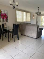 Spacious backyard featuring children's playground, green lawn and patio in Colinas del Sol Arraiján