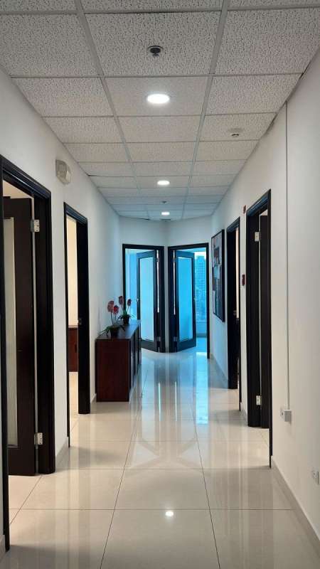 Modern office hallway with glossy tile floor and natural lighting in Ocean Business Plaza Marbella Panama