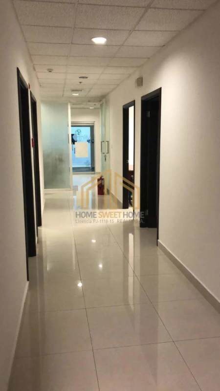 Private executive office with L-shaped desk and large window overlooking Panama City skyline at Ocean Business Plaza