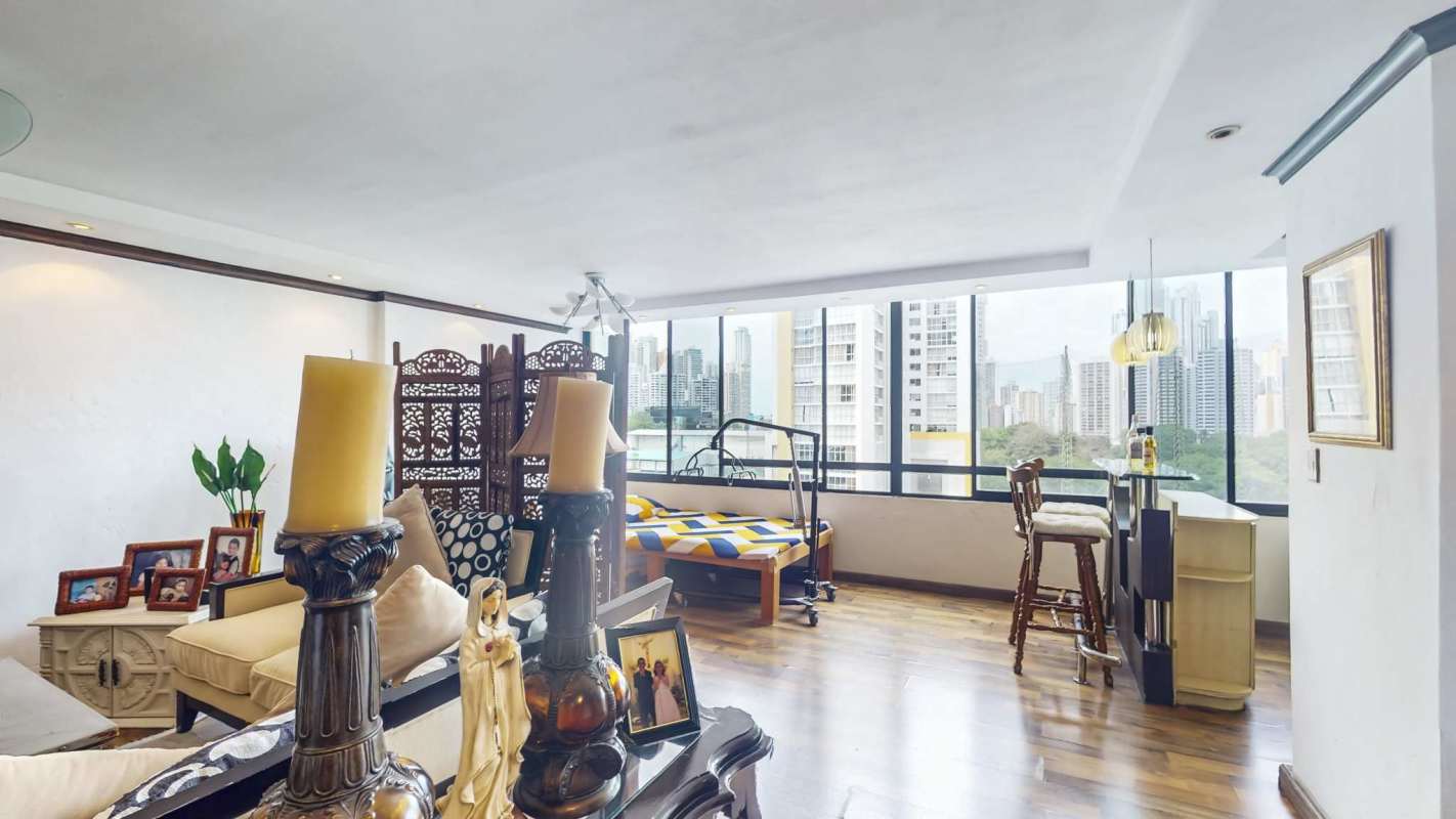 Modern closed kitchen with dark wood cabinets, appliances in PH Torre Buganvilla Panama City