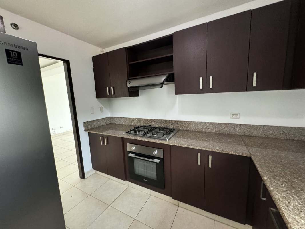Kitchen with granite countertops and dark cabinetry, gas stove in PH Clayton Park Clayton