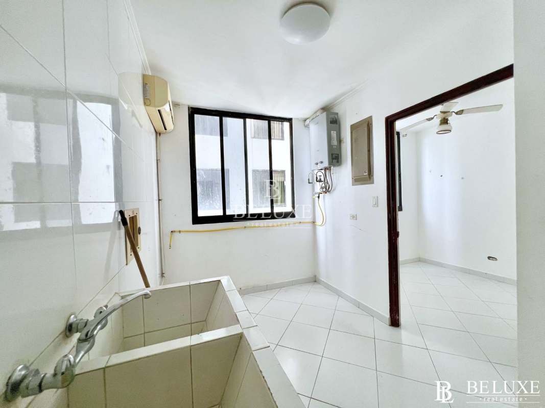 Modern kitchen with red cabinets, stainless appliances, and large island PH Princesa Condesa Panama City