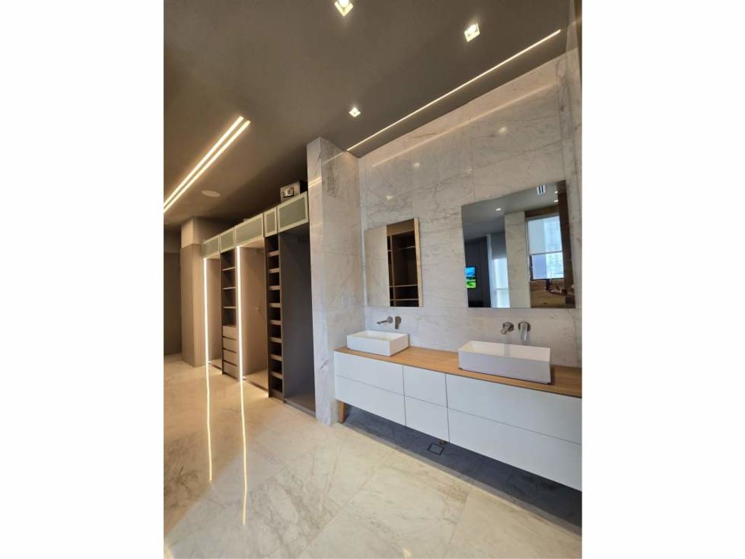 Luxury bathroom with marble walls, double vanity, soaking tub and shower Ocean Reef Islands