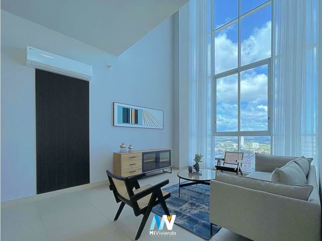 Modern outdoor pool and lounging area with palm trees at PH Country Club Costa del Este