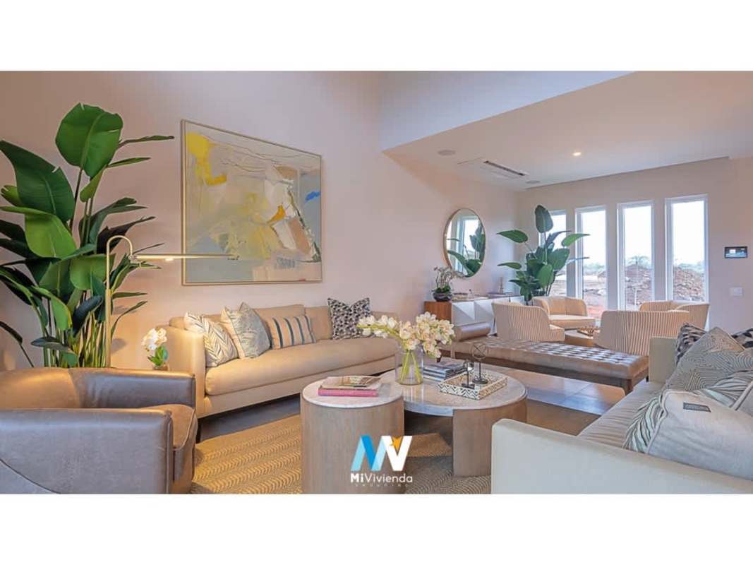 Modern living room with beige sofas, large windows in duplex villa The Woods Santa Maria Panama