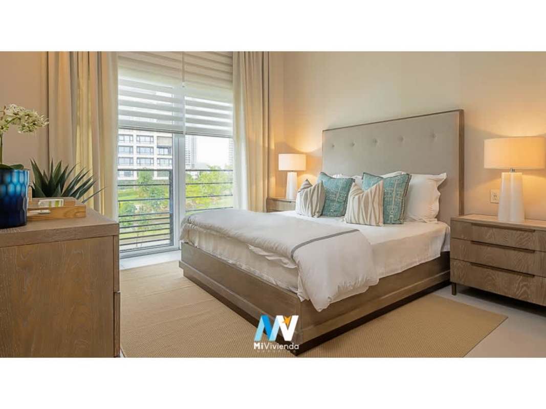 Contemporary living room with two floor heights and large windows in The Woods Panama duplex