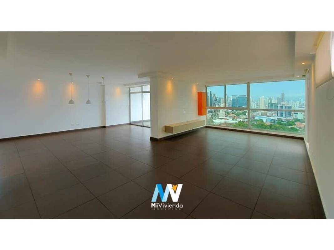 Bright spacious living dining room opens to private terrace with city skyline backdrop