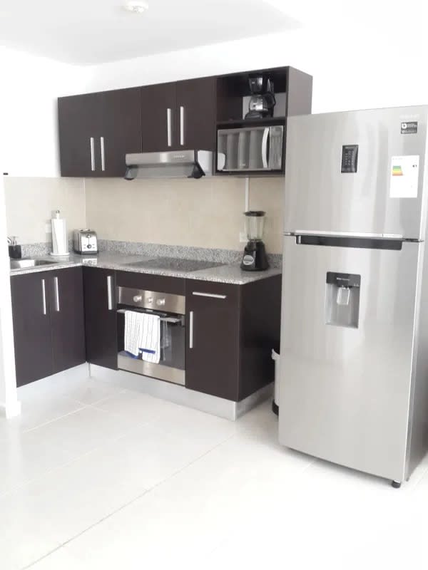 Modern bedroom with ocean view window, AC, and tile floor in PH Bay View Panama City
