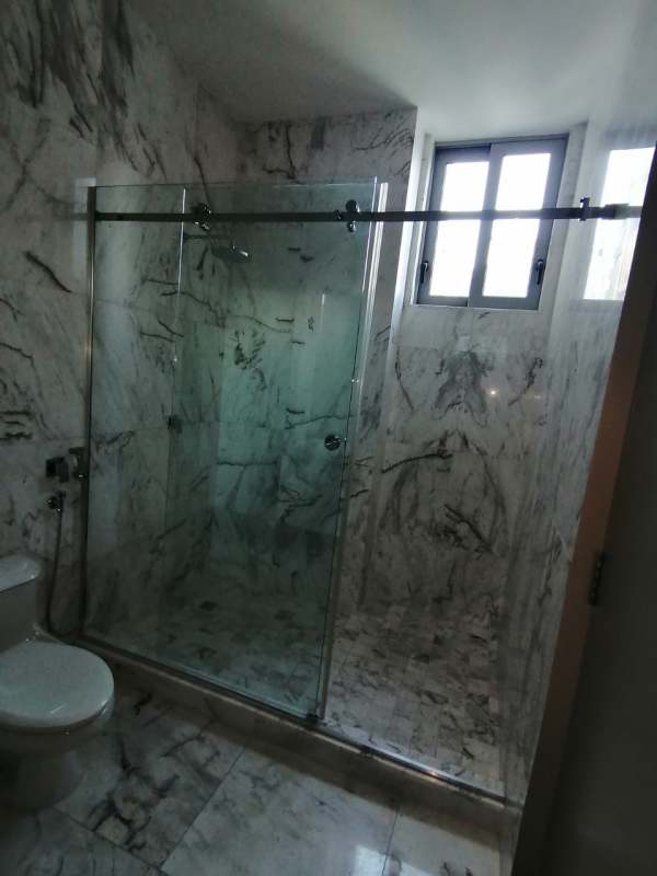 Modern luxury bathroom with marble walls, glass enclosed shower in PH Regalia Costa del Este Panama