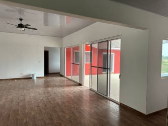 Spacious kitchen with wood cabinets, granite tops and large window in new Las Lajas house Panama