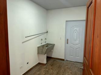 Open modern living room with large sliding glass doors overlooking patio, pool, ocean and hills near Coronado