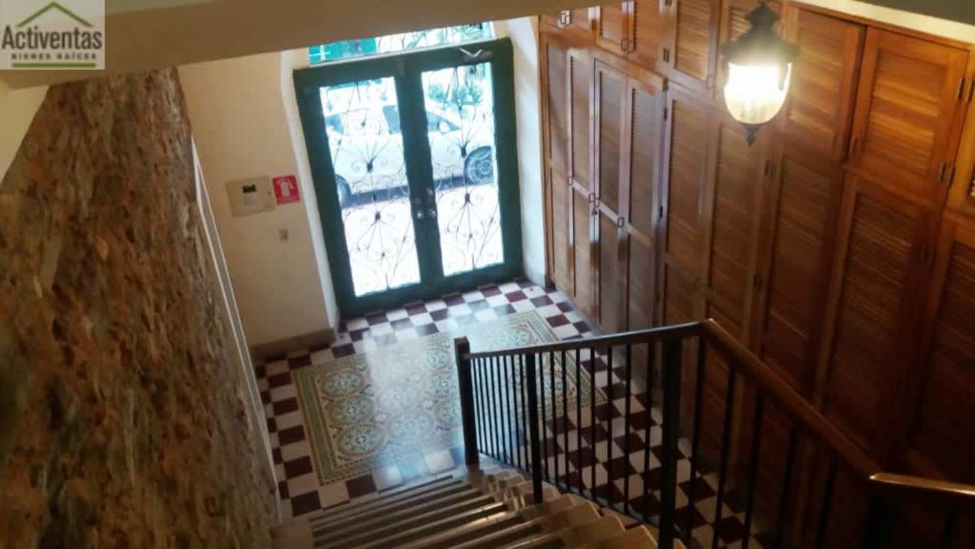 Beautiful tiled colonial entrance with stone wall and glass doors in PH Casco Viejo Panama