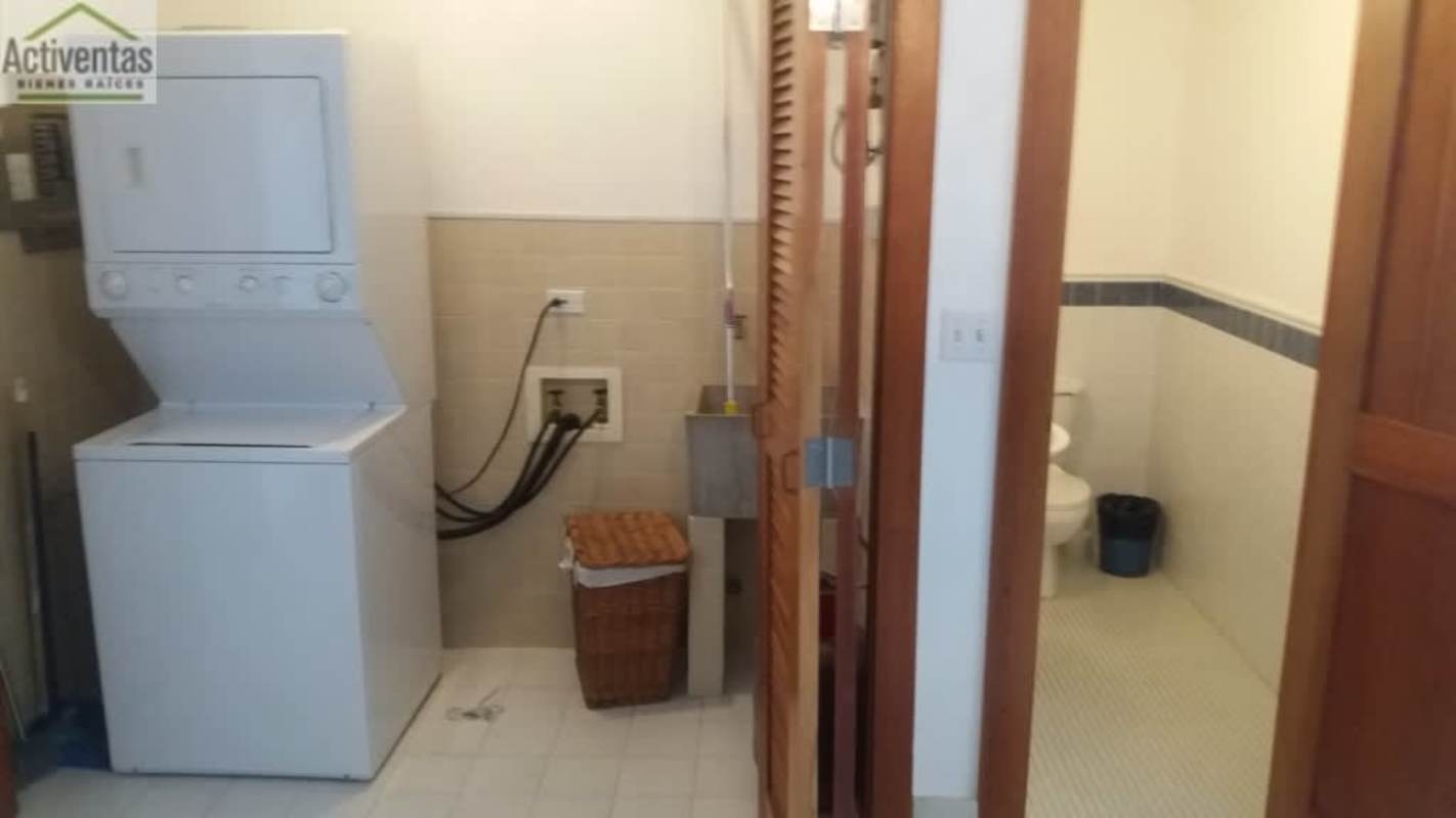 Laundry area with appliances and half bathroom in Casco Antiguo Panama City condo