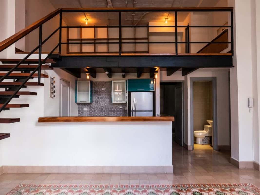 Open-plan loft with mezzanine kitchen floating stairs in Casco Viejo apartment Panama