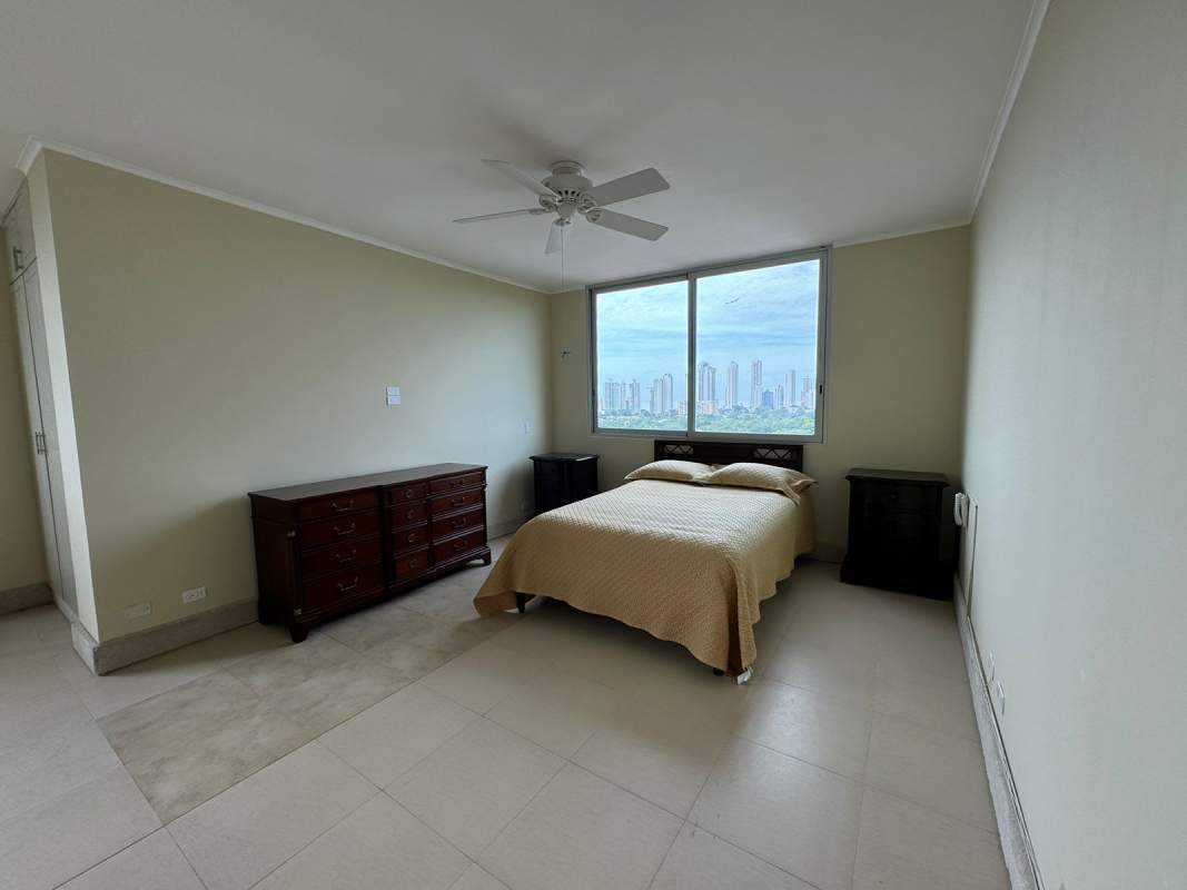 Spacious bedroom with large windows overlooking city skyline in PH Park One Altos del Golf Panama