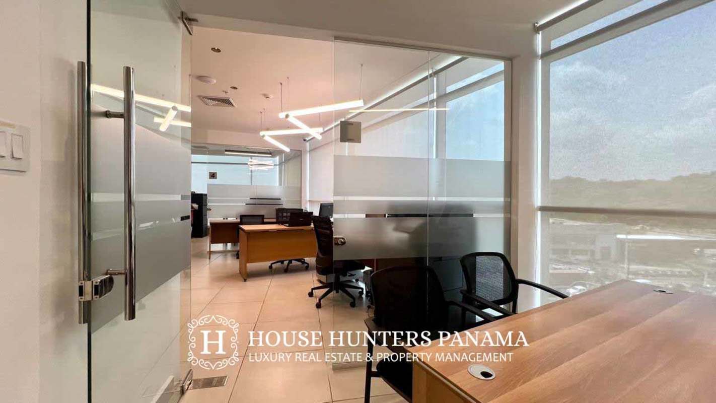 Hallway with glass-enclosed offices and tiled floors business center Panama