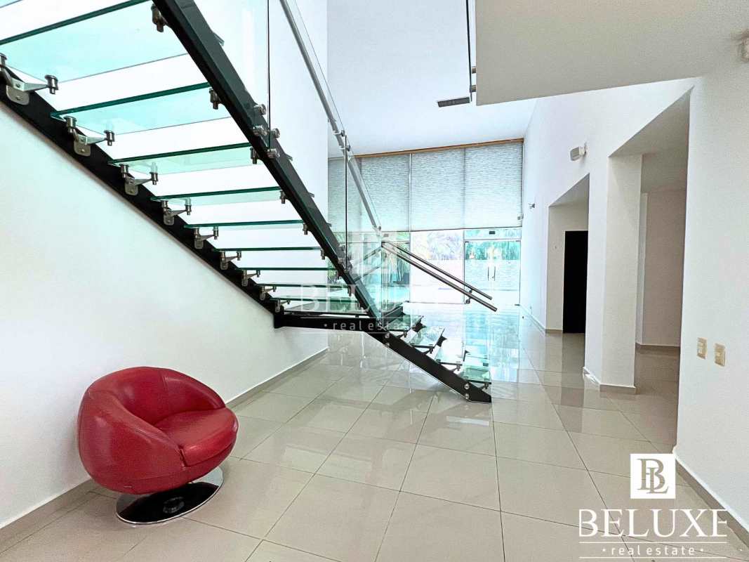 Elegant double-height living room with large windows in luxury house Costa Sur Panama