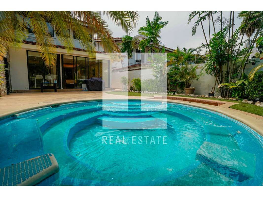 Dining room area with view to patio and living space in Obarrio residential house Panama