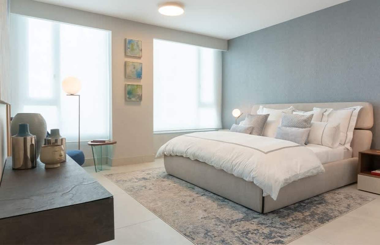 Modern bedroom with large windows overlooking Pacific Ocean at Murano Tower Coco del Mar