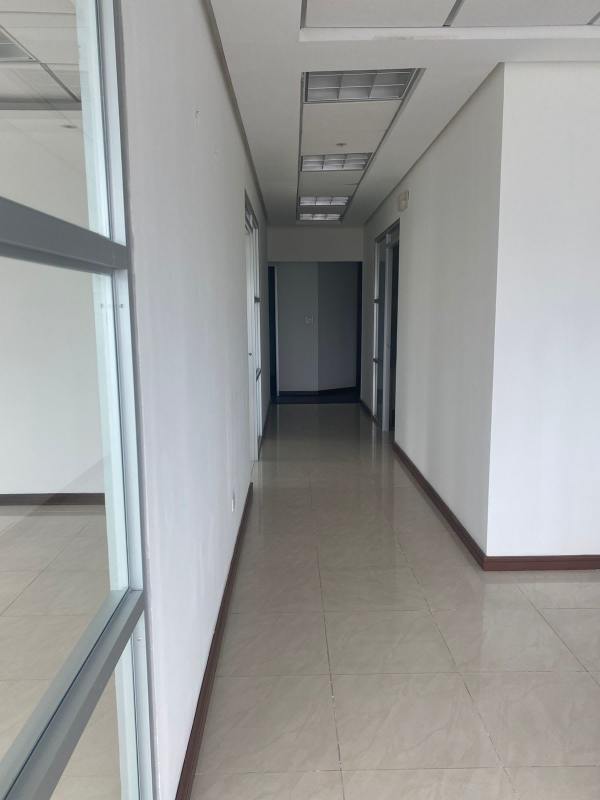 Glass partitions and tile hallway inside Torre Banesco business offices Panama