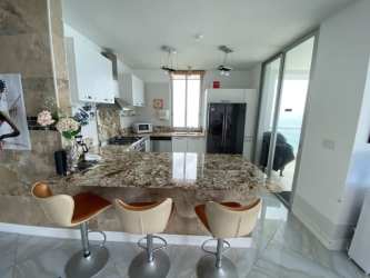 Multiple waterfront pools surrounded by palm trees at PH La Mare Playa San José Panama