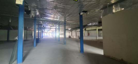Open concrete warehouse interior in Zona Libre de Colón with blue columns