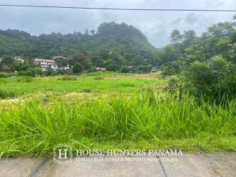 Vacant development lot near Boquete town with lush mountain backdrops, roadside access