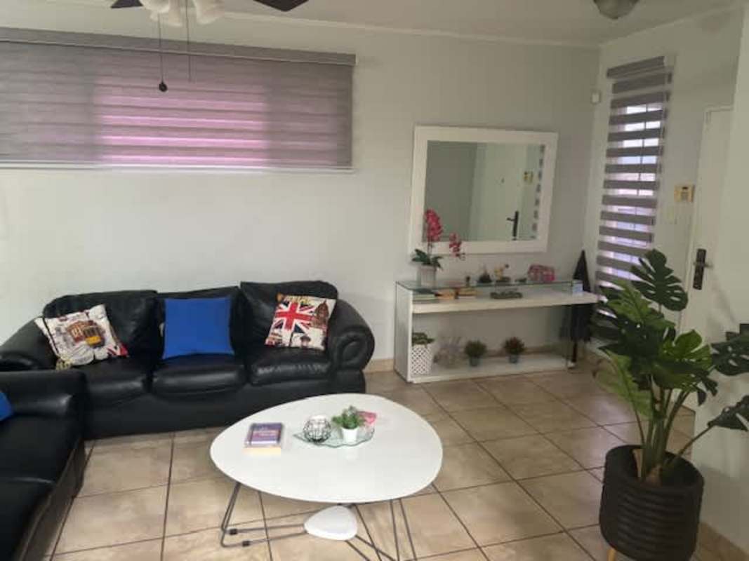 Open living and dining area with tile floor and ceiling fan in Brisas del Golf duplex Panama City