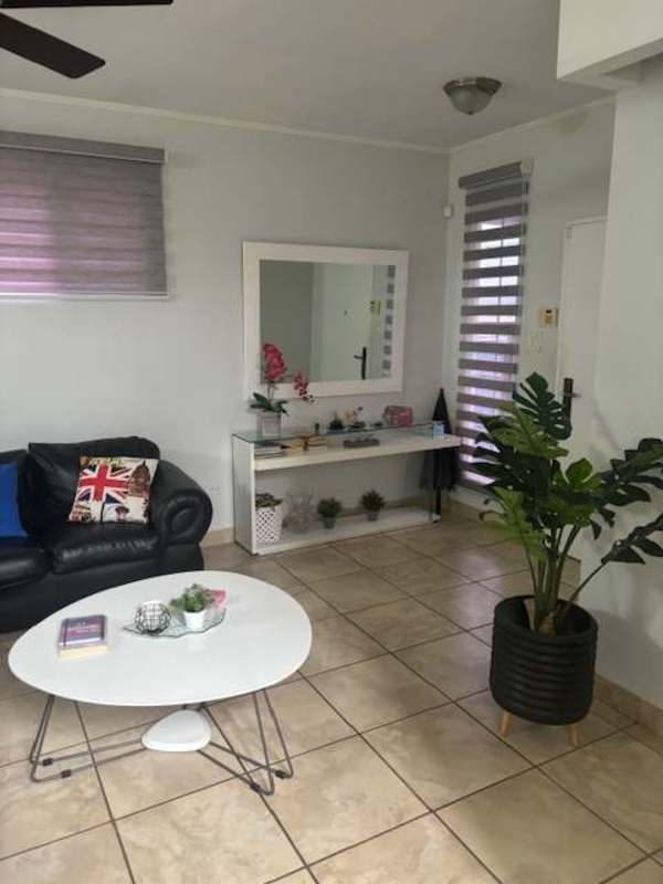 Kitchen with granite countertops, stainless steel appliances, white cabinets in Brisas del Golf duplex Panama