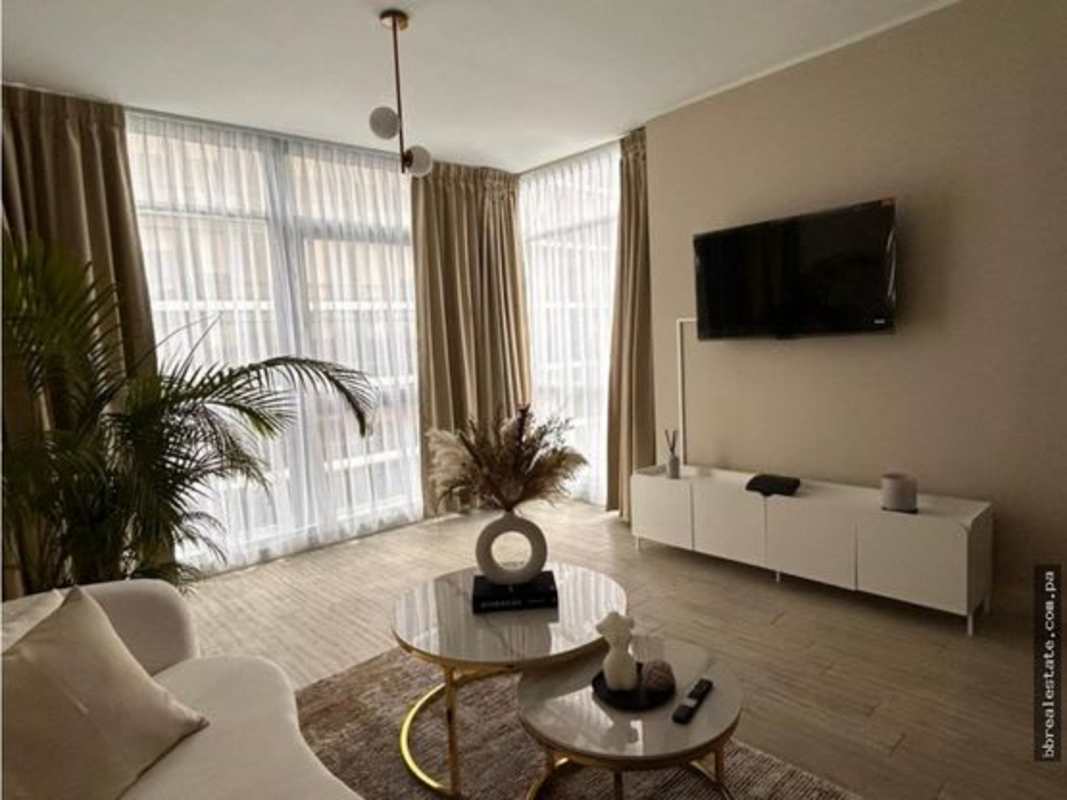 Modern living room with beige curtains, sofa, marble coffee tables in PH Quartier Atlapa San Francisco Panama