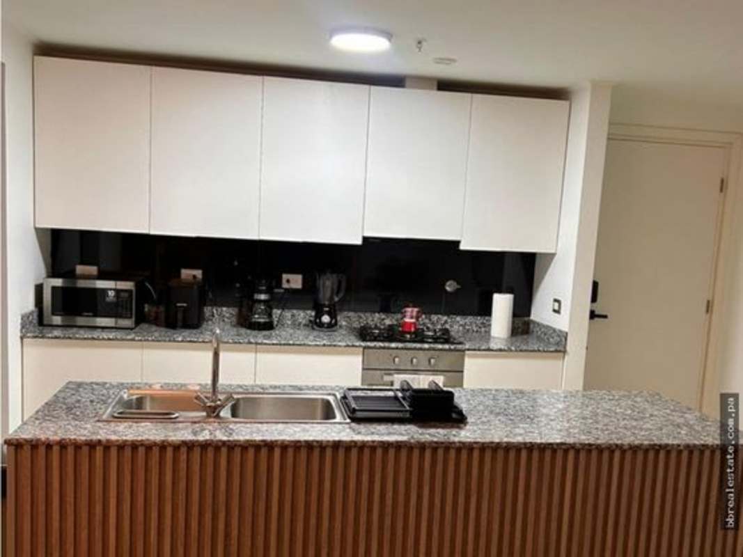 Bathroom showcasing floating wood vanity, wave tile wall, and large mirror at PH Quartier Atlapa San Francisco Panama