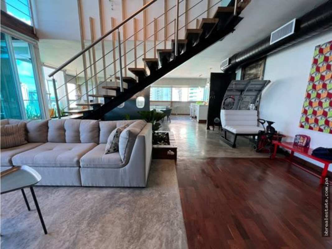 Open plan dining and living room with panoramic floor-to-ceiling windows in luxury penthouse for rent Punta Pacifica