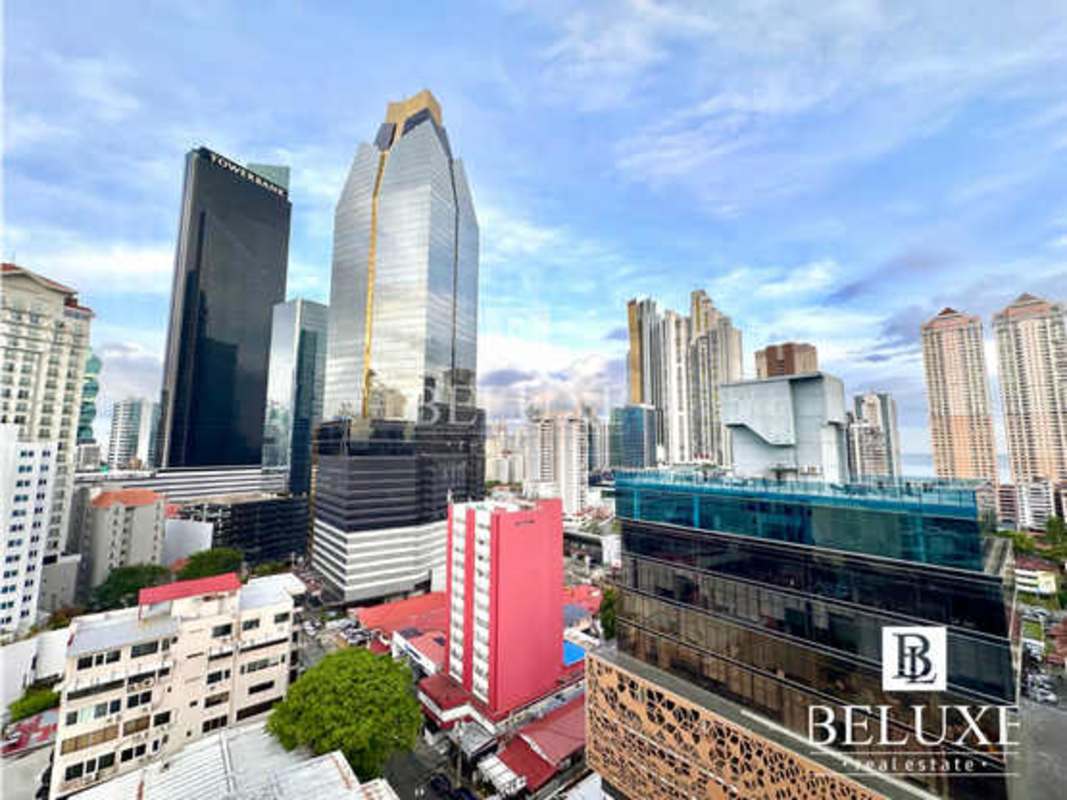 Outdoor swimming pool with city skyline view at PH Vista Tower Bella Vista Panama City