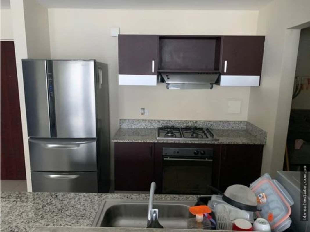 Living room with floor-to-ceiling windows, gray sectional sofa, tiled floors in PH Vitro Loft El Cangrejo Panama