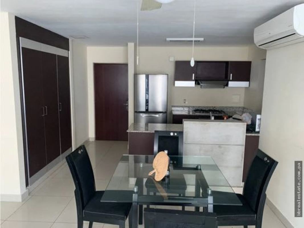 Dining space with glass table, modern kitchen background PH Vitro Loft El Cangrejo