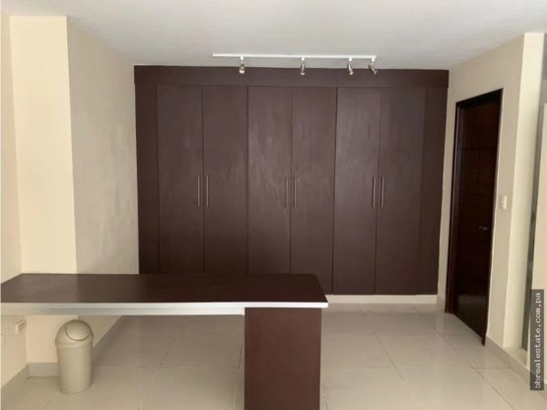 Bedroom or office with built-in wardrobes and track lighting at PH Vitro Loft El Cangrejo Panama
