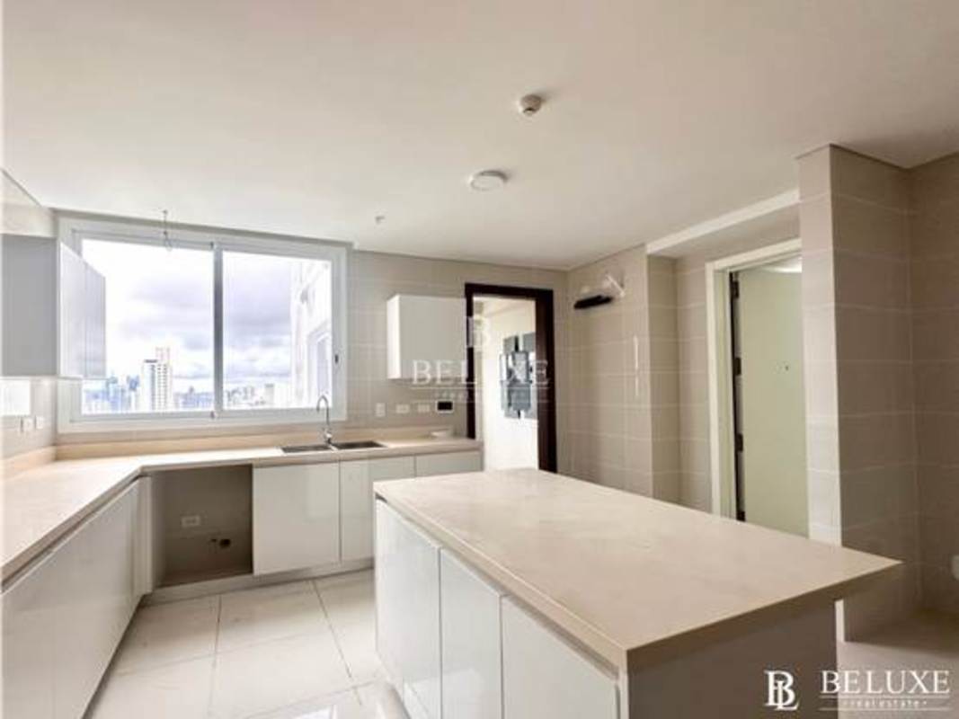 Contemporary kitchen with large windows, center island and city view PH Windrose Coco del Mar Panama