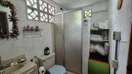 Rustic covered patio with ceiling fan and outdoor dining at Playa Corona San Carlos