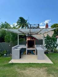 Coral stone swimming pool with shallow lounge playita area at beach villa Cala Azul Costa Esmeralda