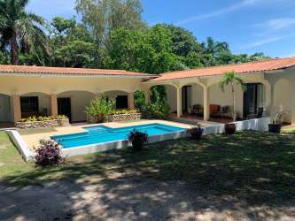 Large green garden with fruit trees and pool view beachside house Coronado Panama