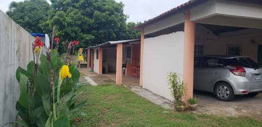 Front of bungalow beach house with carport and garden in Playa Malibu Gorgona Panama