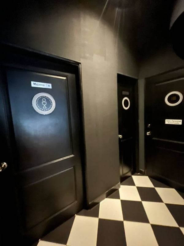 Hall with black doors to restrooms, modern design, checkered tile floor in Panama commercial unit