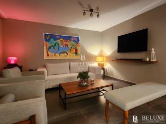 Living room with beige sofa, artwork, ambient lighting PH Las Islas Punta Barco Panama