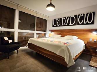 Bedroom with large window overlooking garden PH Las Islas Punta Barco Panama