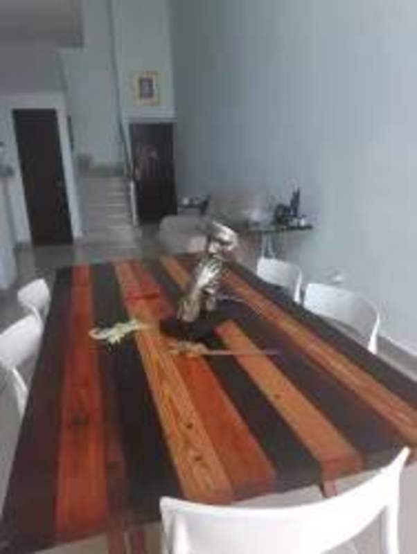 Modern dining with striped table and double height ceilings Famagosta Loft Panama