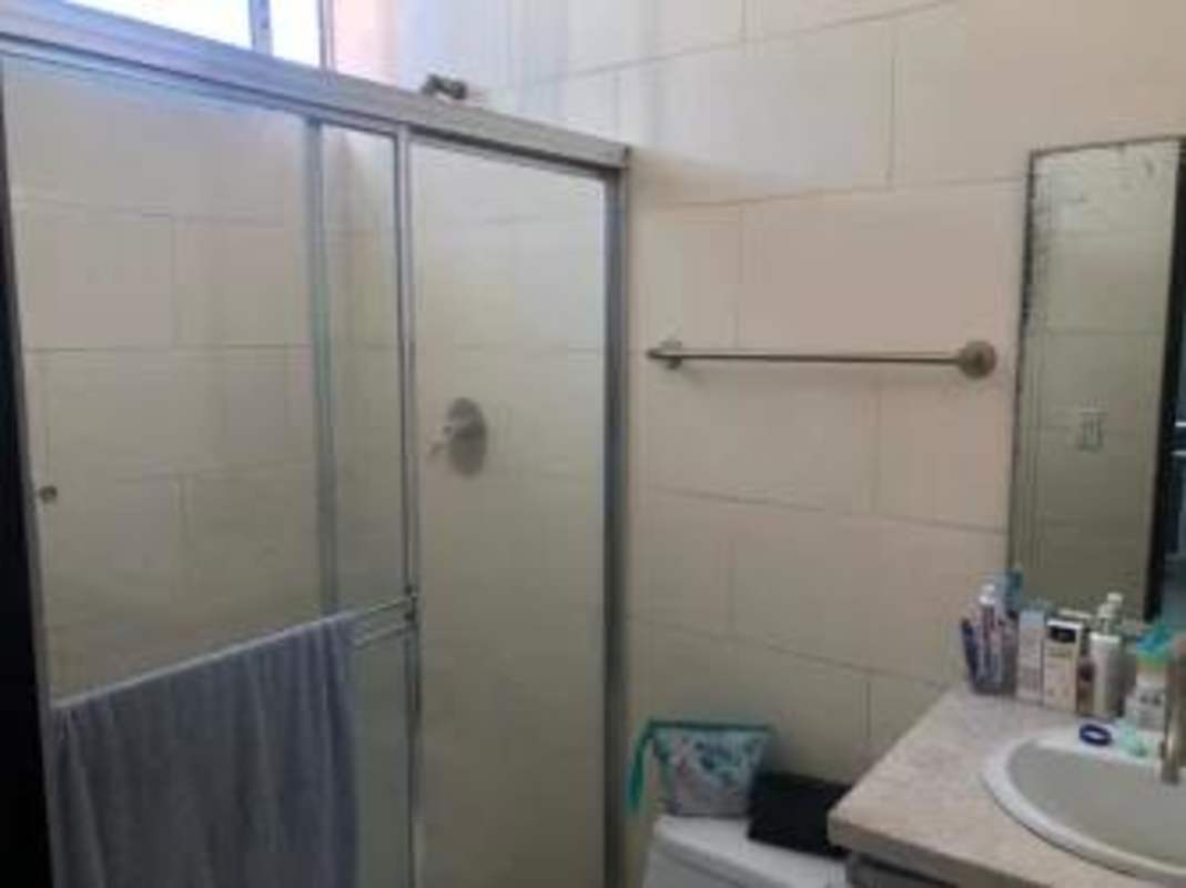 Bathroom with glass enclosed shower, sleek fixtures PH Famagosta Loft Panama