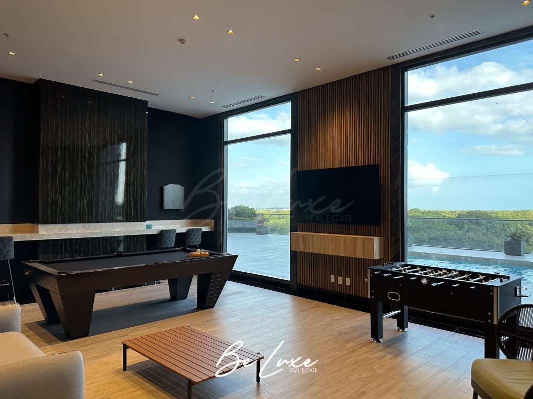 Large modern living room with marble floors and ocean golf views at PH Empire Residences Santa María Panama City