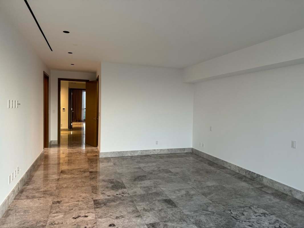 Luxury gym with modern equipment floor-to-ceiling windows and golf course views at Empire Residences Panama