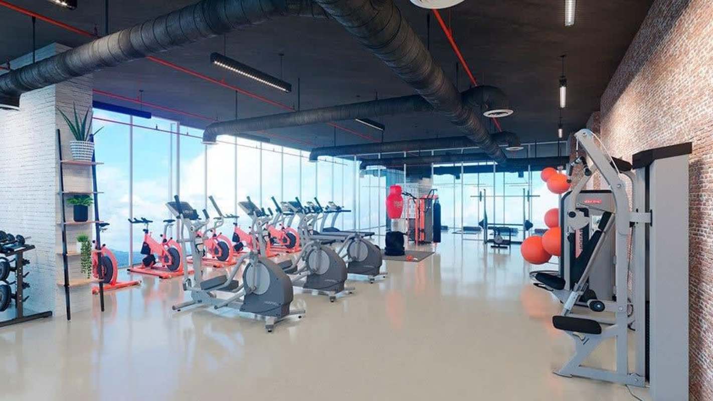 Fully equipped gym exposed brick modern industrial design Generation Tower Panama condo amenities