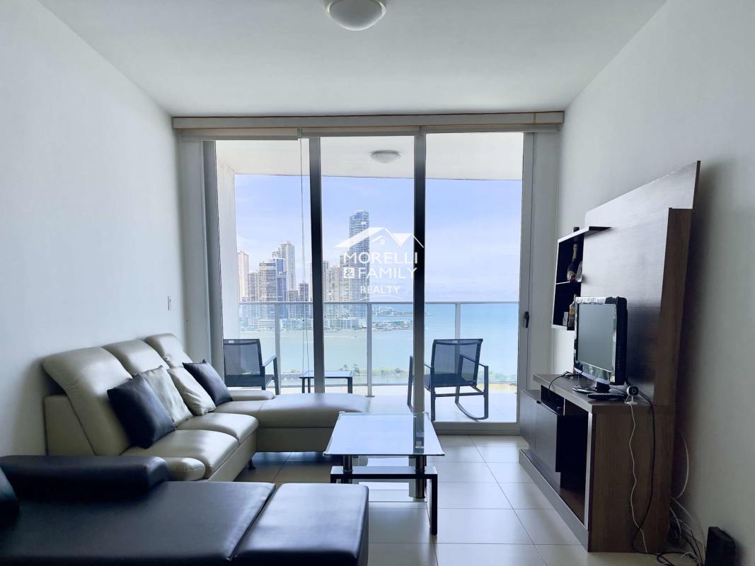 Modern bedroom with large windows showcasing panoramic waterfront and city skyline at PH BICSA Apartment Balboa Panama